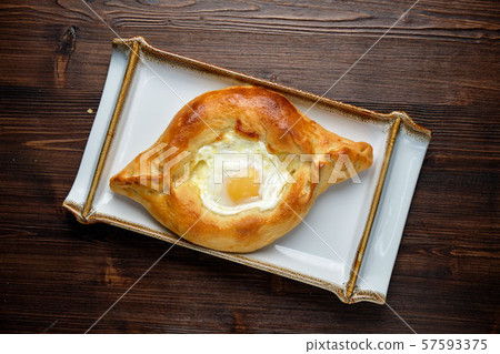 Khachapuri with egg in Adjarian. restaurant menu Khachapuri with egg in Adjarian. restaurant menu 57593375