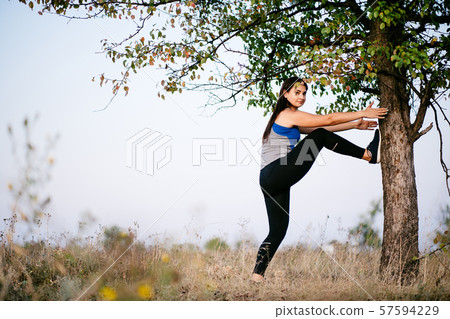 Runner doing stretching exercise before workout 57594229