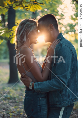 Young loving couple kissing and enjoying the company of each other outdoors 57596049
