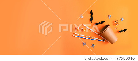 Halloween holiday decorations. Striped straws with Halloween holiday decorations. Striped straws with 57599010