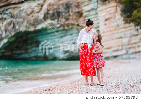 Mother and little daughter enjoying time at tropical beach Mother and little daughter enjoying time at tropical beach 57599798