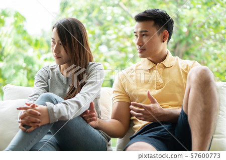 Unhappy Couple sitting behind each other on the 57600773