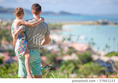 Young father and little girl enjoying beautiful views of exotic island Young father and little girl enjoying beautiful views of exotic island 57601233