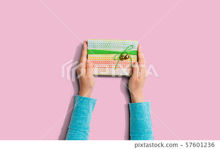 Person holding a gift box 57601236