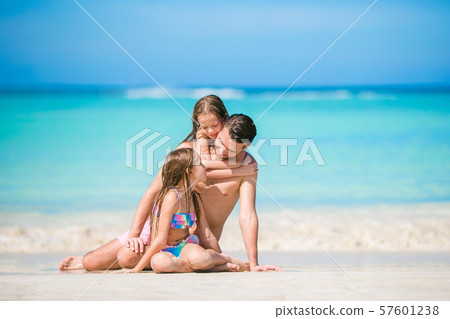 Father and kids enjoying beach summer vacation Father and kids enjoying beach summer vacation 57601238