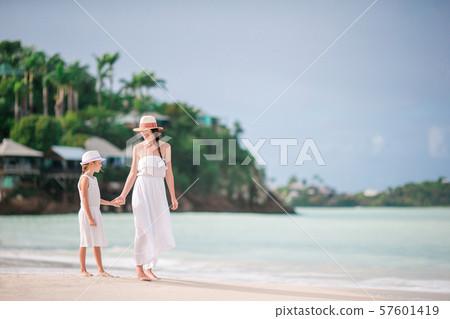 Beautiful mother and daughter on Caribbean beach Beautiful mother and daughter on Caribbean beach 57601419
