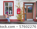 Women tourist looking the red old mailbox  57602276