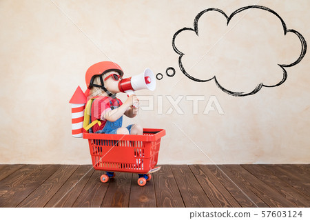 Kid playing with toy rocket at home Kid playing with toy rocket at home 57603124