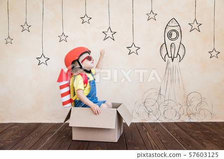 Kid playing with toy rocket at home 57603125