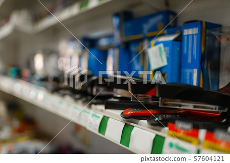 Shelf with staplers in stationery store, nobody Shelf with staplers in stationery store, nobody 57604121