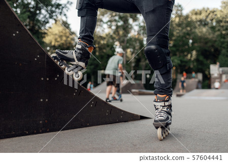 Roller skating, skater standing on ramp in park 57604441