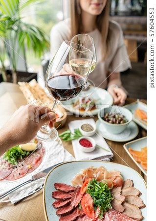 Portrait of a beautiful young elegant woman in the restaurant with a wine glass. Dinner and a 57604551