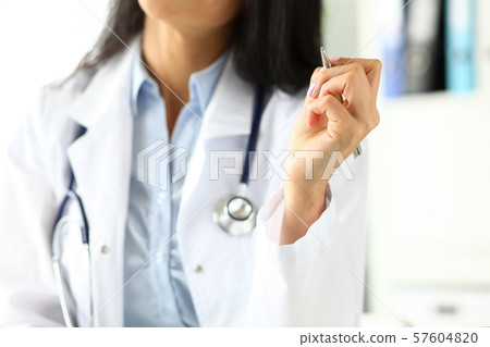 Arm of female GP sitting at worktable Arm of female GP sitting at worktable 57604820