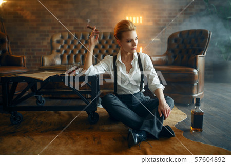 Woman relax with whiskey and cigar, retro fashion Woman relax with whiskey and cigar, retro fashion 57604892