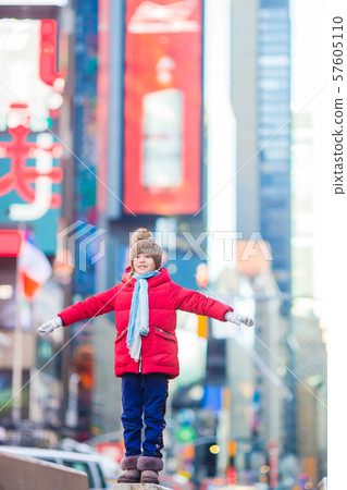 Adorable little girls have fun on Times Square in New York City Adorable little girls have fun on Times Square in New York City 57605110