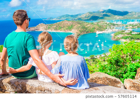 Adorable little kids and young father enjoying the view of picturesque English Harbour at Antigua in 57605114