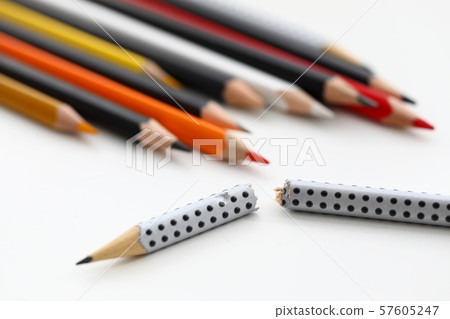Grey wrecked pencil lying in front of multicolored fellows Grey wrecked pencil lying in front of multicolored fellows 57605247