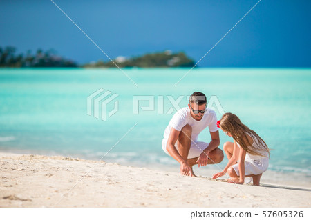 Family of father and little girl having fun on the beach Family of father and little girl having fun on the beach 57605326