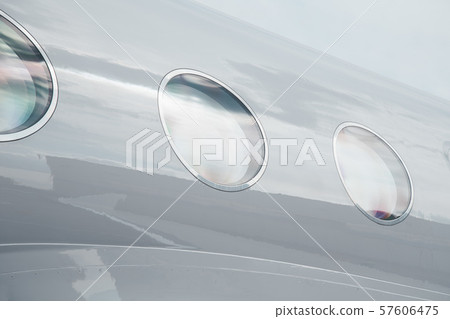 passenger porthole window of business airplane jet at outside at sunny day 57606475