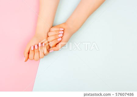 Hands of a beautiful woman on a colorful background. Hands of a beautiful woman on a colorful background. 57607486