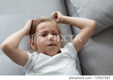 The girl scratches her head, severe itching, infection with lice 57607987