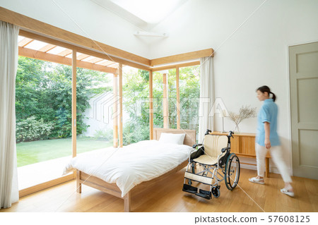 Caregiver care facility wheelchair hospital room medical image 57608125