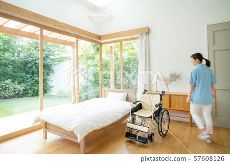 Caregiver care facility wheelchair hospital room medical image 57608126