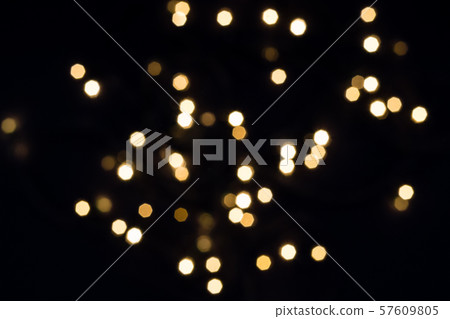 Flying golden bokeh lights in hexagon shape on 57609805
