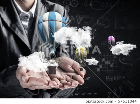 Woman presenting flying balloon in hand. Woman presenting flying balloon in hand. 57611044
