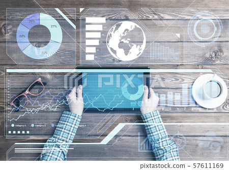 Business workplace with tablet device coffee cup and media graphs and diagrams Business workplace with tablet device coffee cup and media graphs and diagrams 57611169