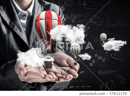 Woman presenting flying balloon in hand. Woman presenting flying balloon in hand. 57611170