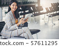 Business women sit and wait at passenger boarding 57611295