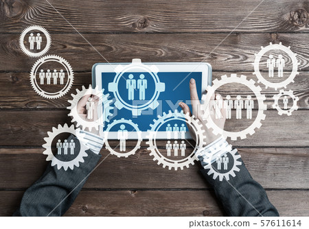 Concept of teamworking and connection with gears mechanism and tablet pc Concept of teamworking and connection with gears mechanism and tablet pc 57611614