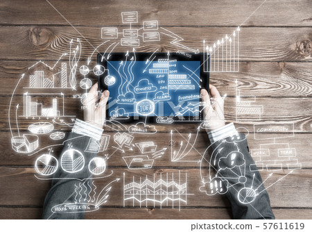 Concept of business strategy and planning with tablet on wooden table Concept of business strategy and planning with tablet on wooden table 57611619