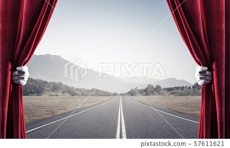 Asphalt road behind red curtain and hand holding it Asphalt road behind red curtain and hand holding it 57611621