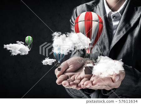 Woman presenting flying balloon in hand. Woman presenting flying balloon in hand. 57611634