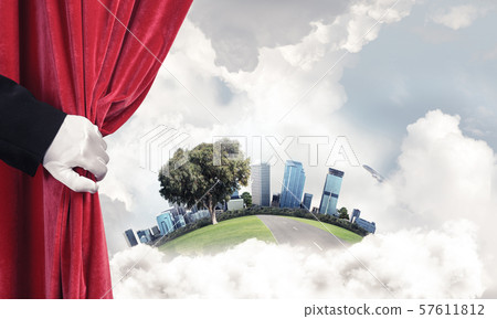 Modern cityscape behind drapery curtain and hand opening it Modern cityscape behind drapery curtain and hand opening it 57611812