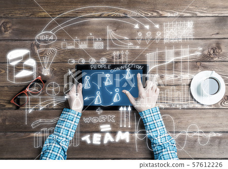 Concept of business strategy and planning with tablet on wooden table Concept of business strategy and planning with tablet on wooden table 57612226