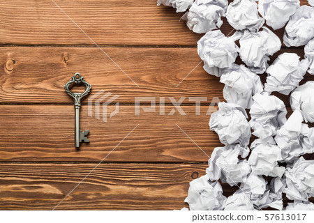 Concept of success and opportunity with old key among paperballs 57613017