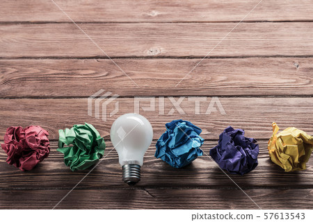 Ideological concept with wastepaper light bulb on wooden table 57613543