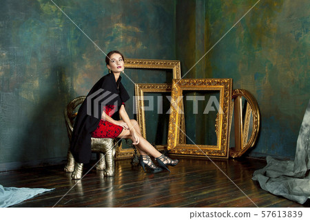 beauty rich brunette woman in luxury interior near empty frames, wearing fashion clothes, lifestyle 57613839