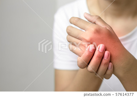 Female holding hand to spot of pain hand. Female holding hand to spot of pain hand. 57614377