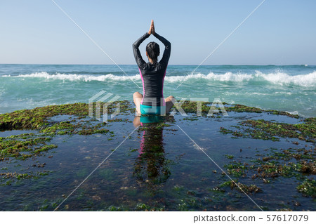 Woman practice yoga at the seaside coral cliff Woman practice yoga at the seaside coral cliff 57617079