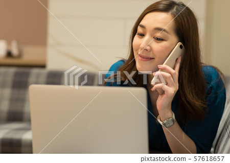 A woman who makes internet on the sofa A woman who makes internet on the sofa 57618657