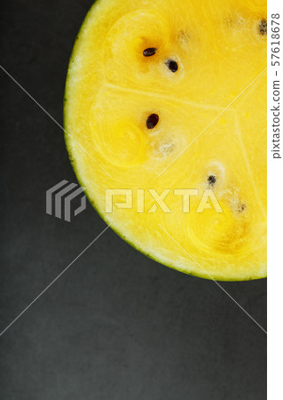 Half yellow watermelon on a black background, 57618678