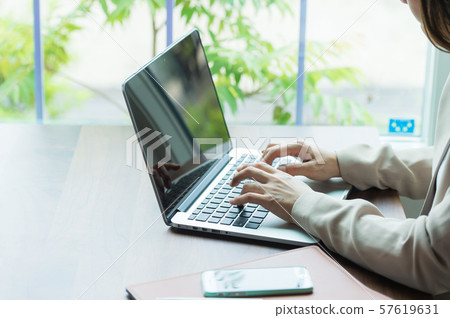 Woman operating a personal computer Woman operating a personal computer 57619631