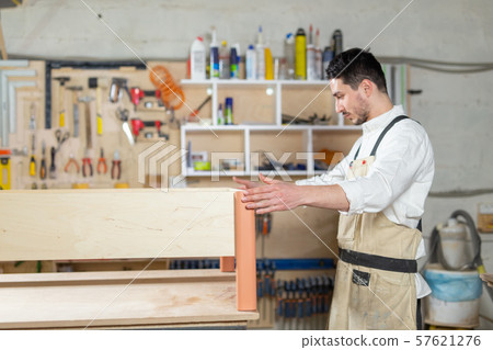 furniture factory, Small-Sized Companies, business concept - man worker at the furniture production furniture factory, Small-Sized Companies, business concept - man worker at the furniture production 57621276
