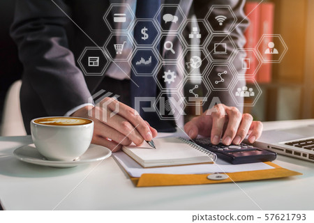 Businessman calculates financials with graph paper on the laptop computer the cost of home office. Businessman calculates financials with graph paper on the laptop computer the cost of home office. 57621793