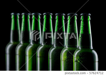 Row of glass bottles of beer 57624712