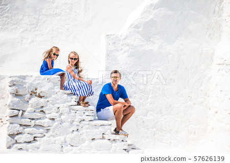 Family having fun outdoors on Mykonos streets 57626139